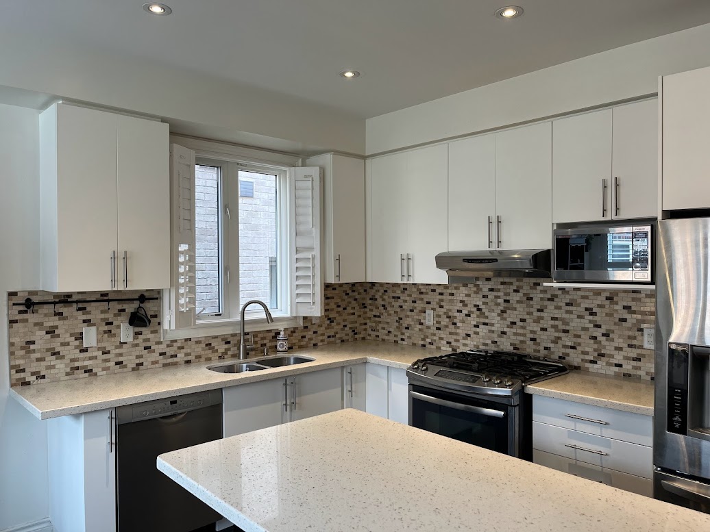AFTER: Kitchen Cabinets and Panels Resurfaced with a Cream White Finish