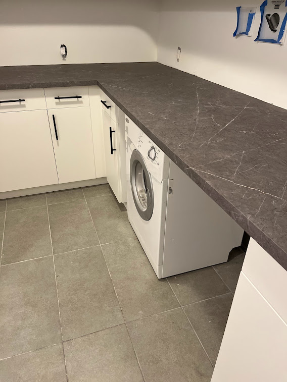 AFTER: Resurfaced Matte White Cabinets Paired with Elegant Marble Surfaces
