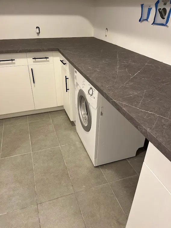 AFTER: Resurfaced Matte White Cabinets Paired with Elegant Marble Surfaces