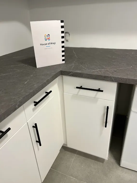 AFTER: Resurfaced Matte White Cabinets Paired with Elegant Marble Surfaces