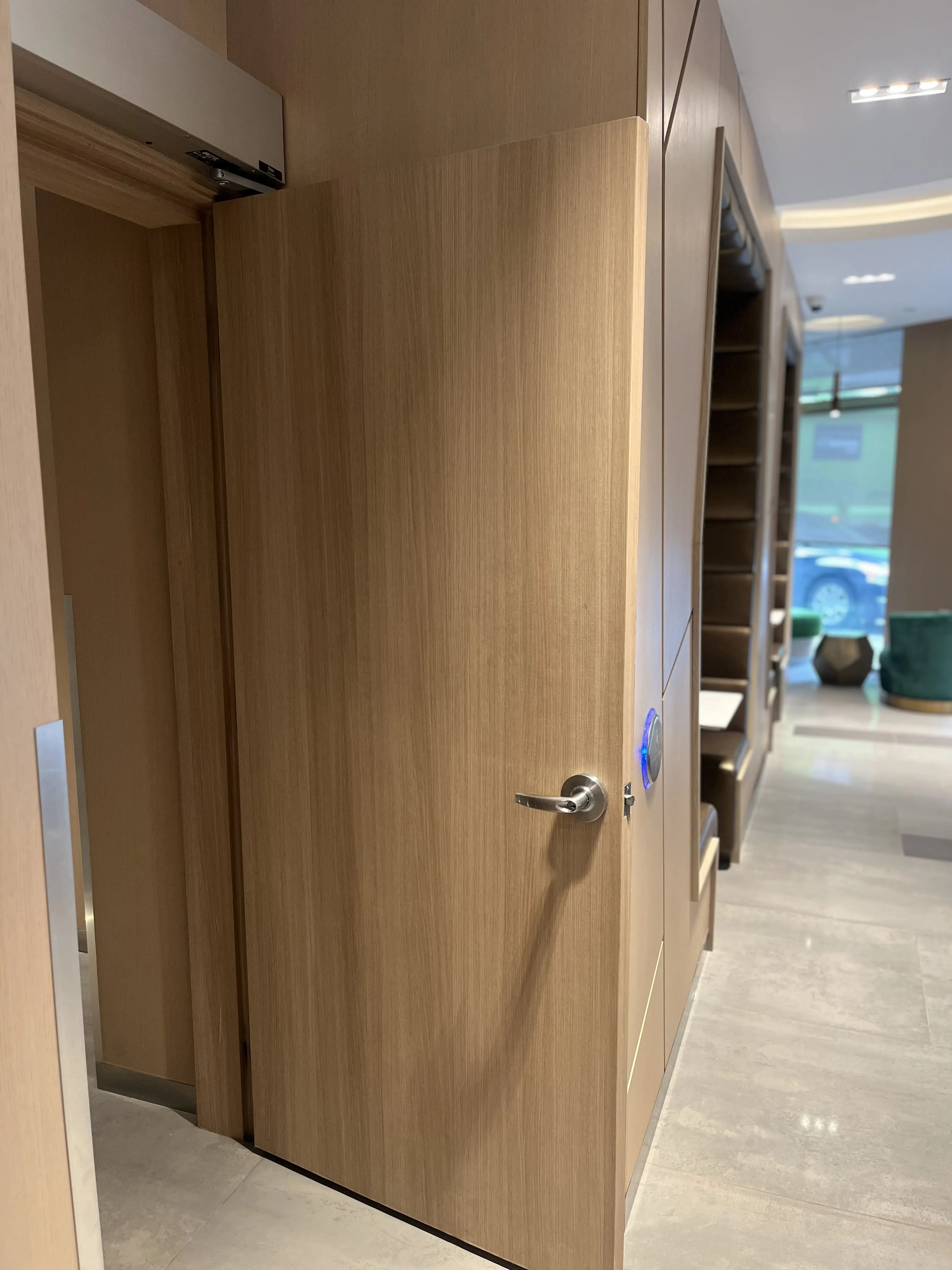 AFTER: Downtown Condominium Lobby Door Resurfaced in Natural Oak