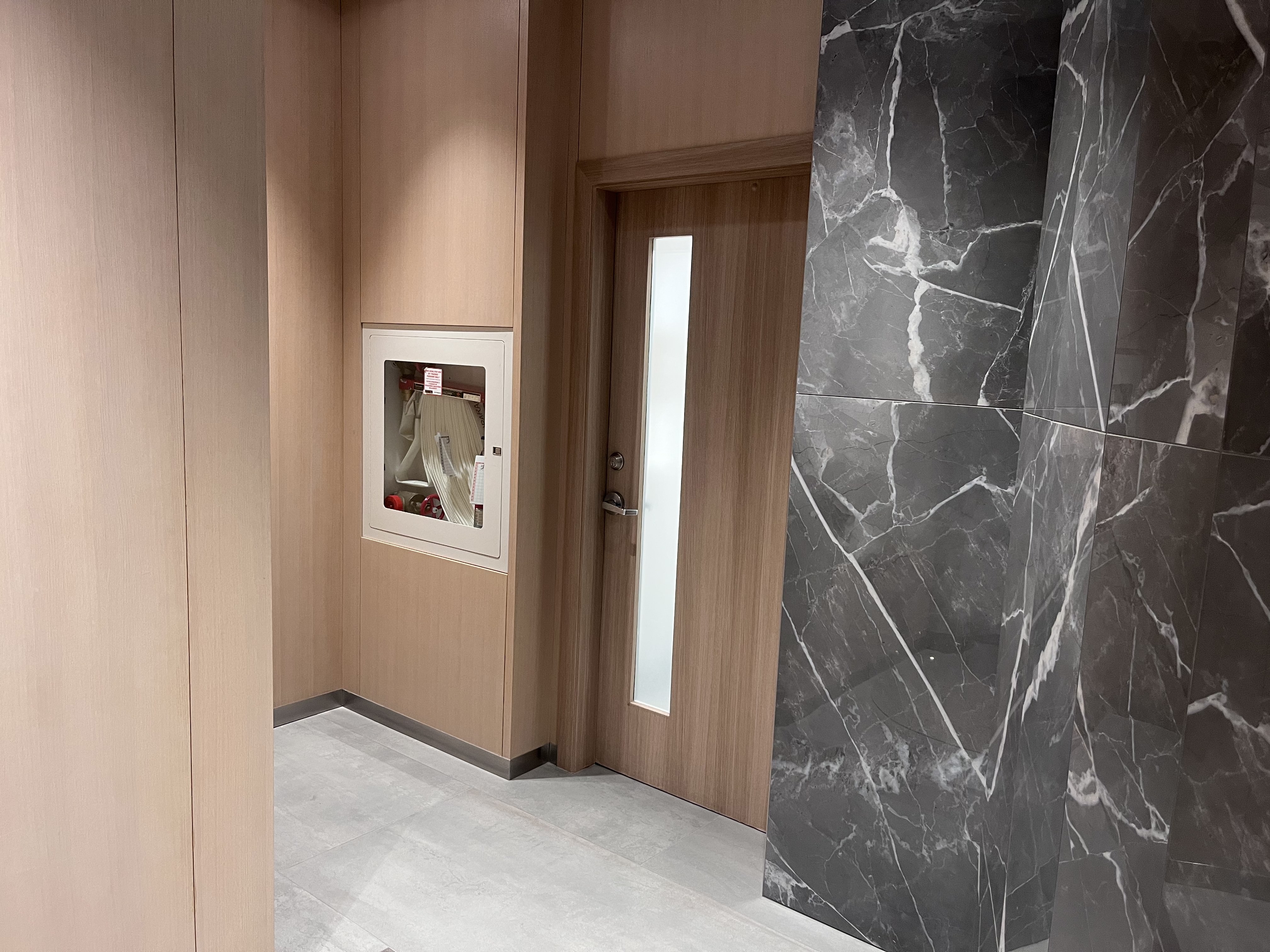 AFTER: Downtown Condominium Lobby Door & Door Frames Resurfaced in Natural Oak