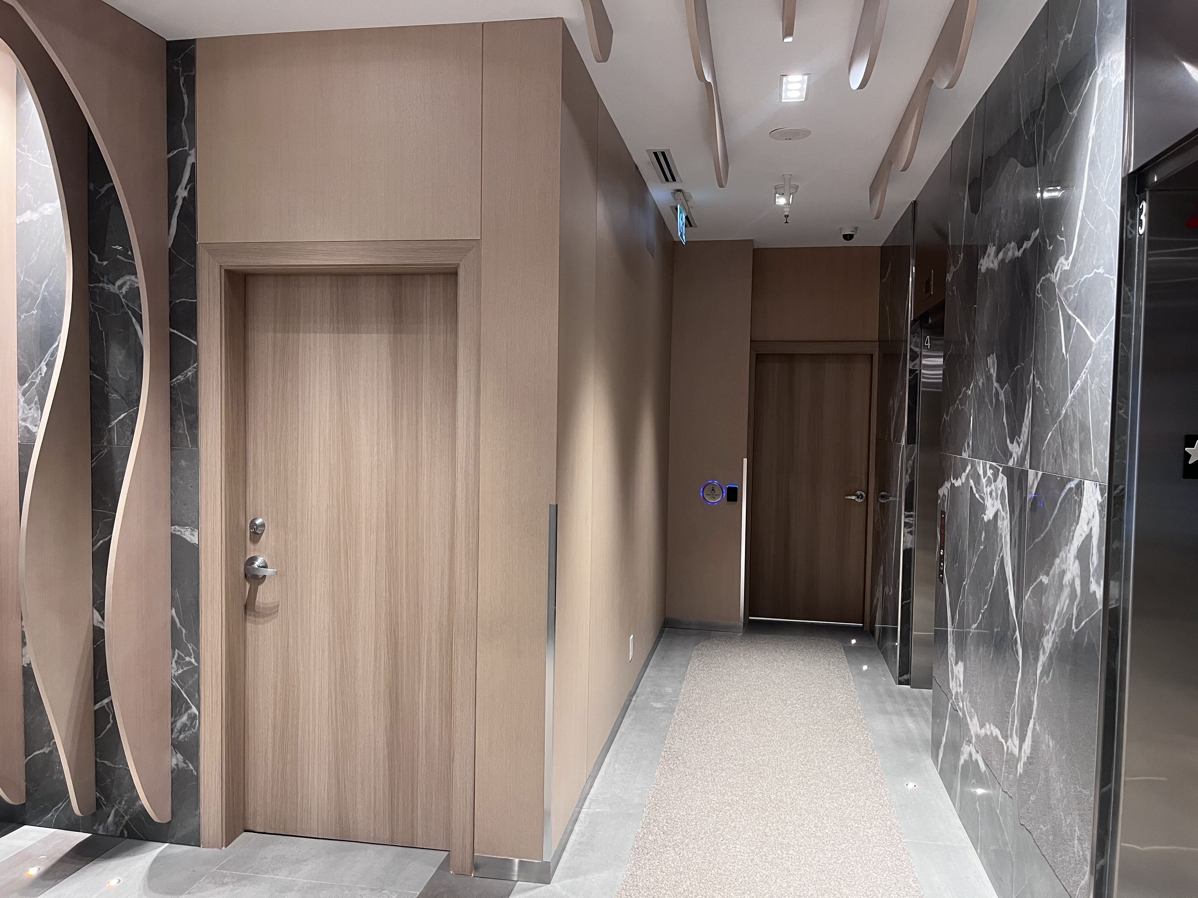 AFTER: Downtown Condominium Lobby Doors & Door Frames Resurfaced in Natural Oak