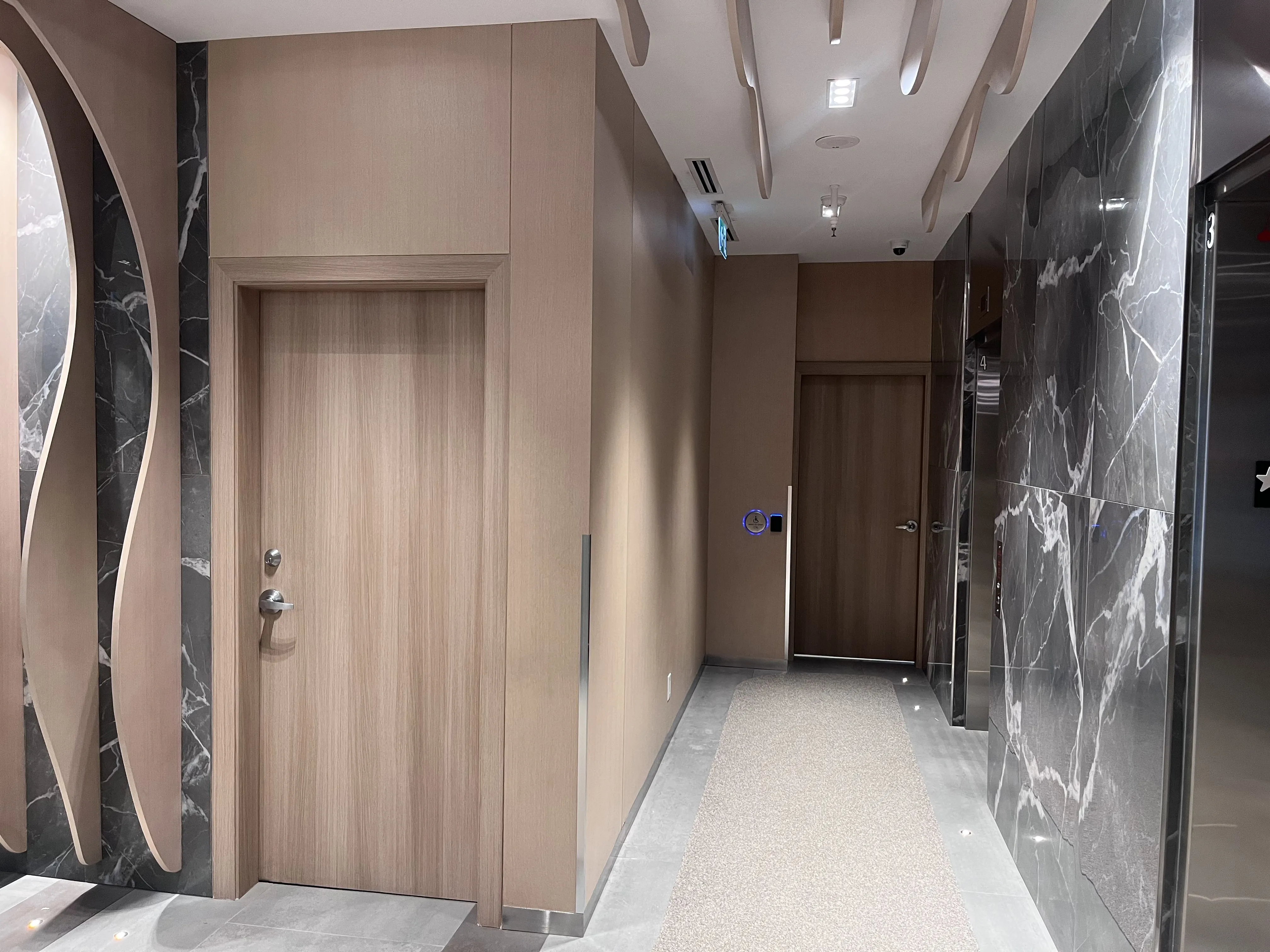 AFTER: Downtown Condominium Lobby Doors & Door Frames Resurfaced in Natural Oak