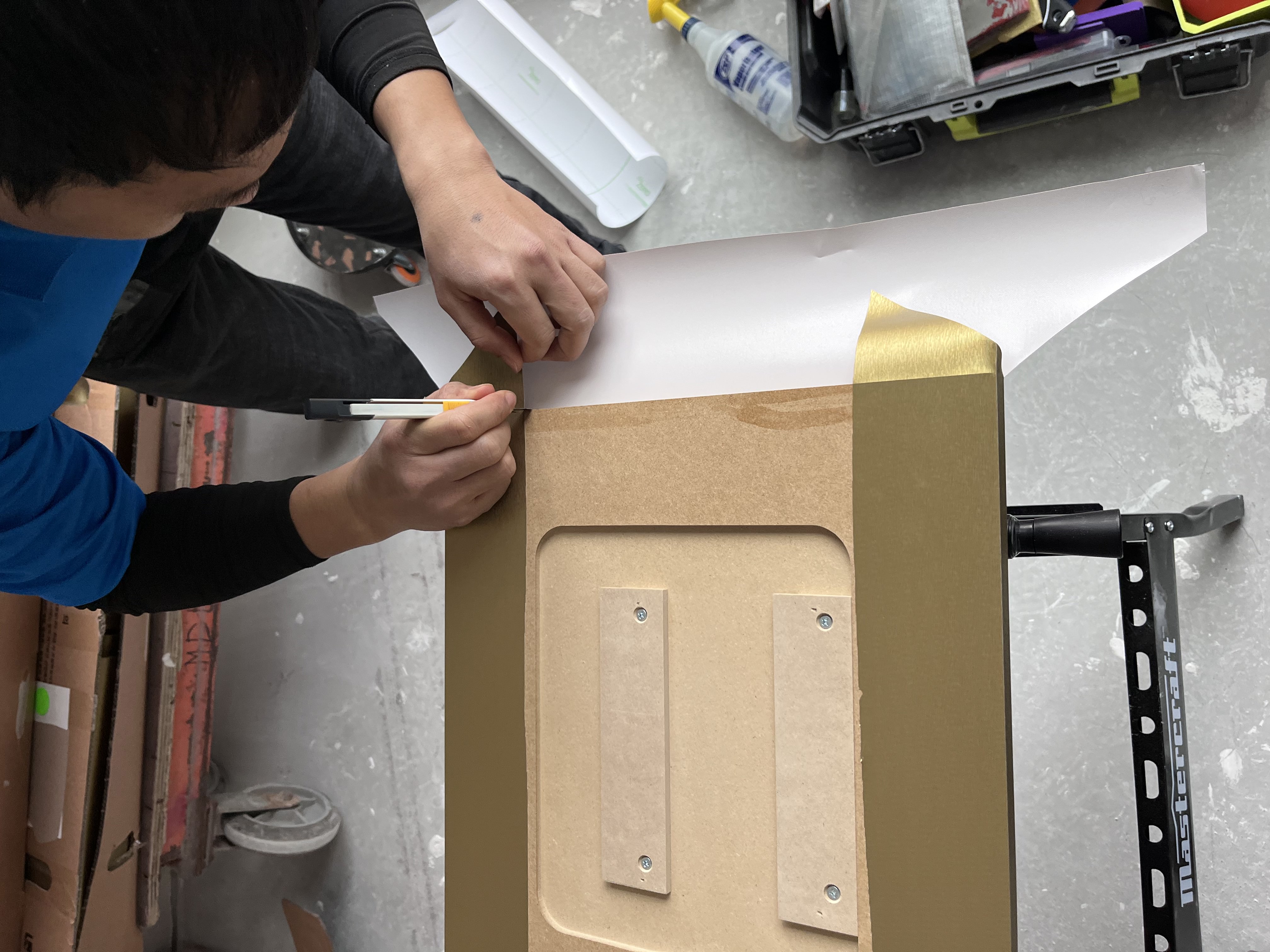 Technician Installing a Panel with a Brass Finish