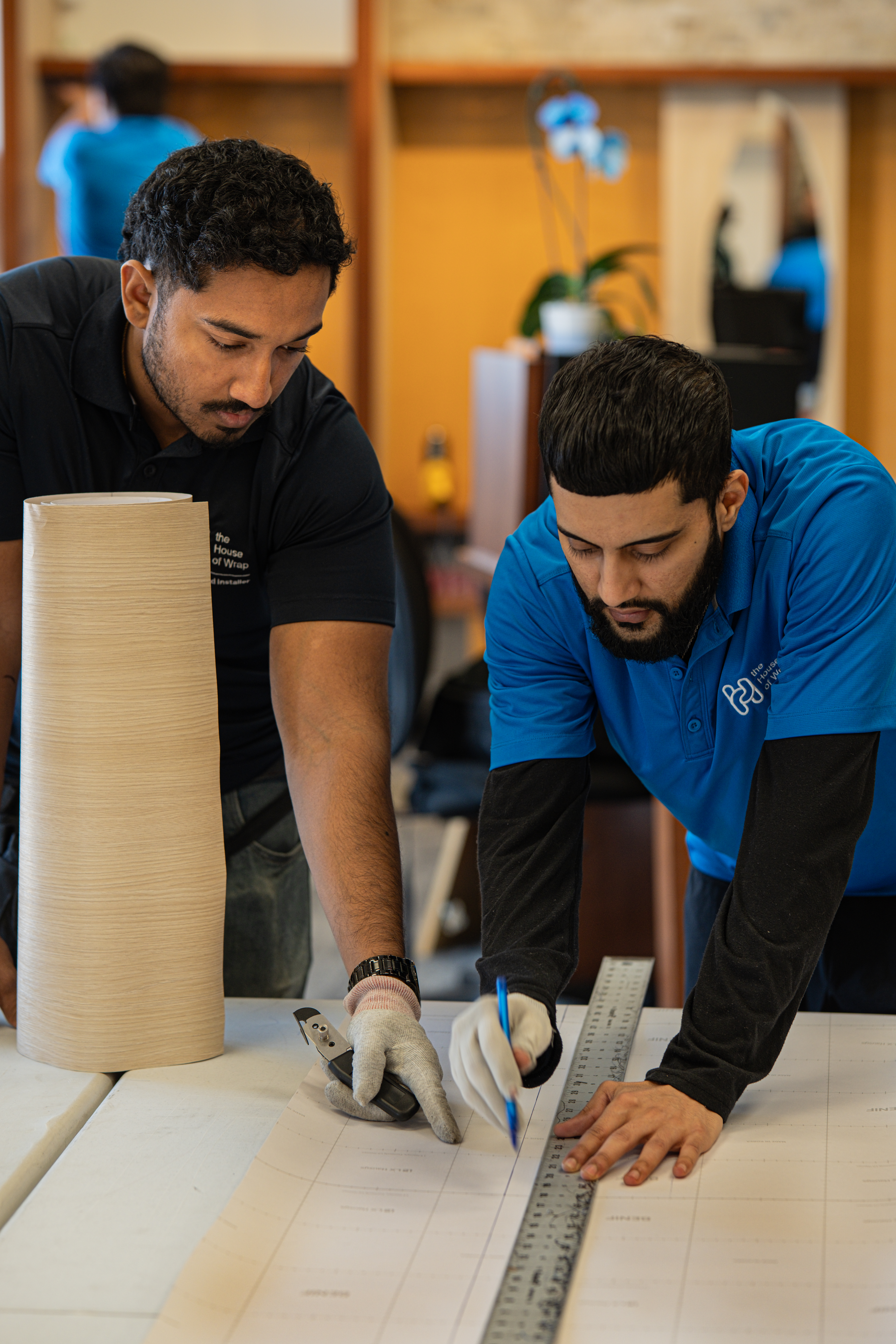 DURING: Team Installing Vinyl on Store Fixtures