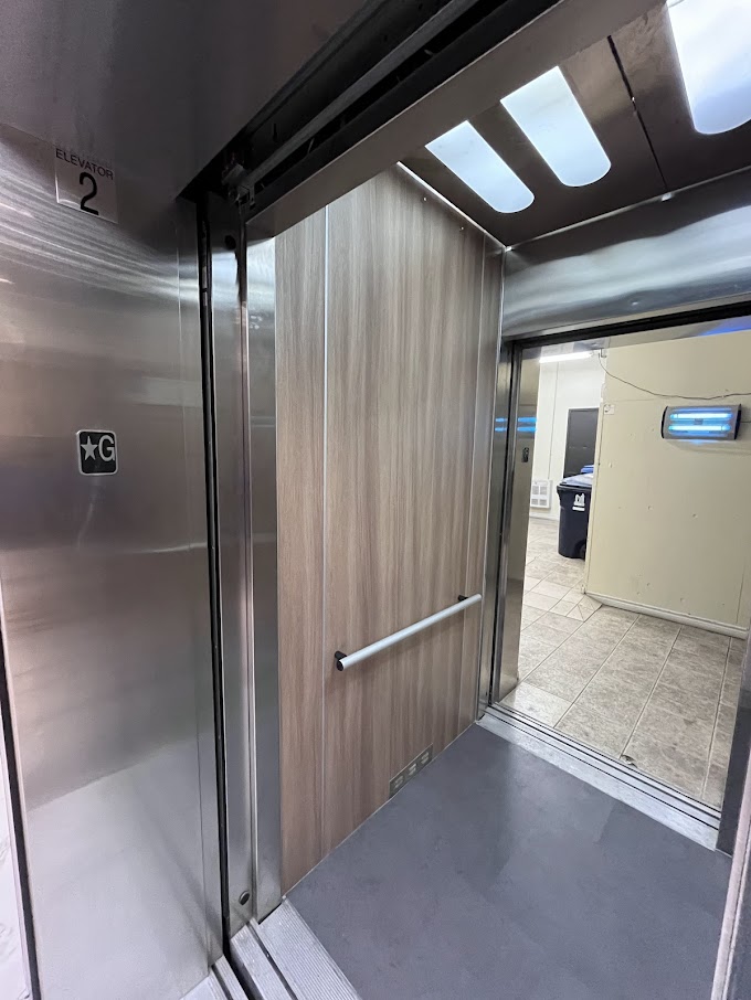 AFTER: Elevator Cabin Panels Resurfaced with a Modern Wood Finish