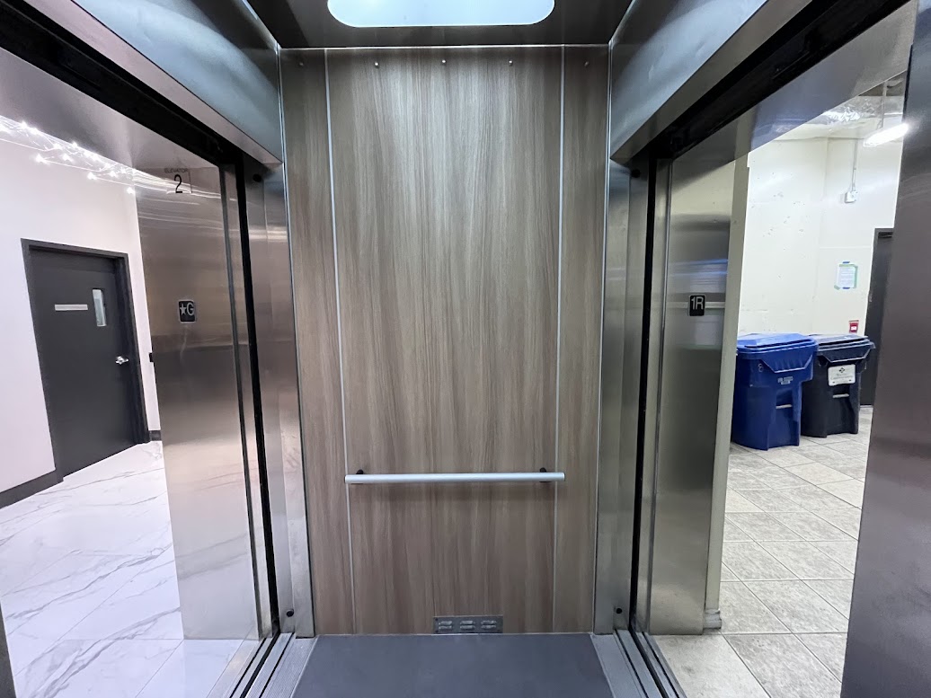 AFTER: Elevator Cabin Panels Resurfaced with a Modern Wood Finish