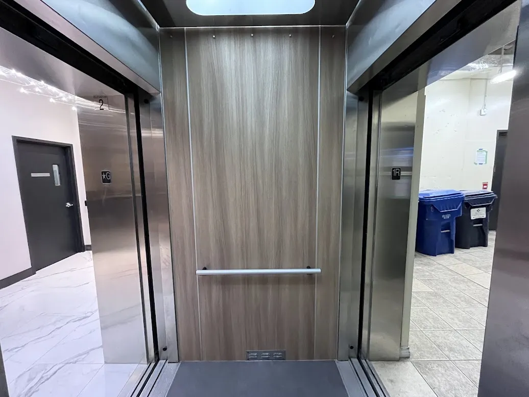 AFTER: Elevator Cabin Panels Resurfaced with a Modern Wood Finish