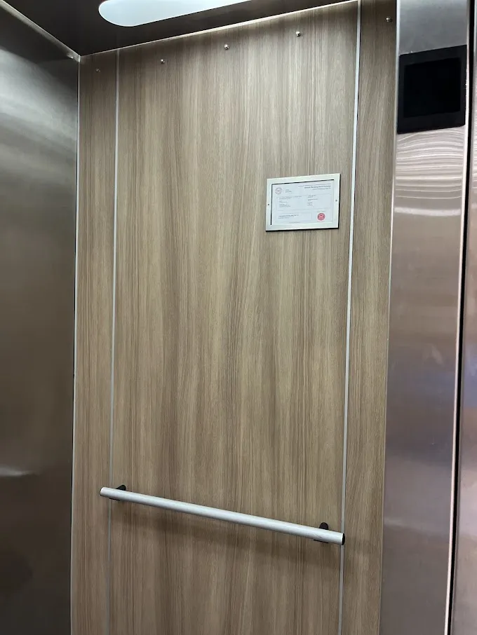 AFTER: Elevator Cabin Panels Resurfaced with a Modern Wood Finish