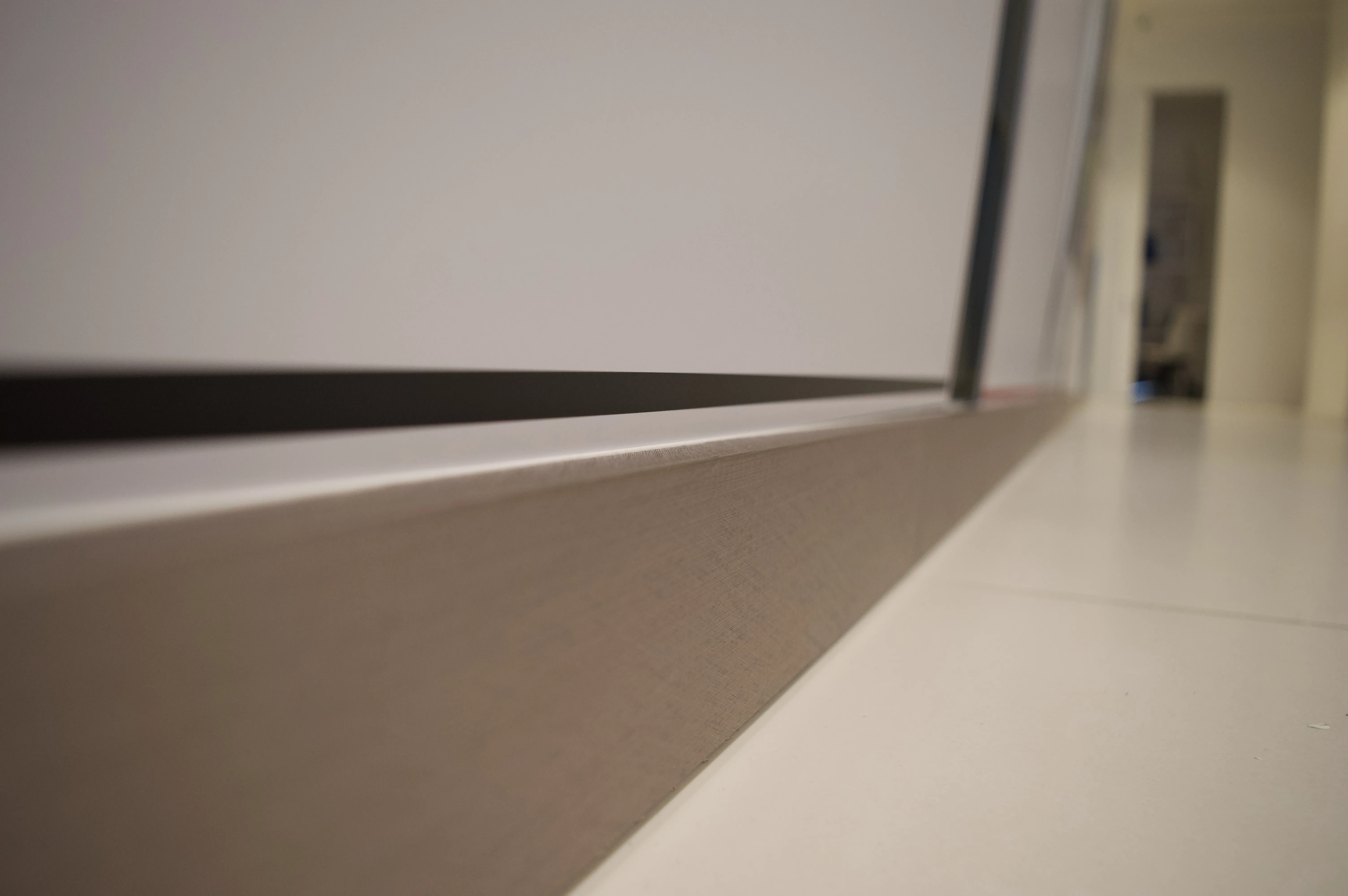 After: Textured Steel Showroom Baseboards Resurface